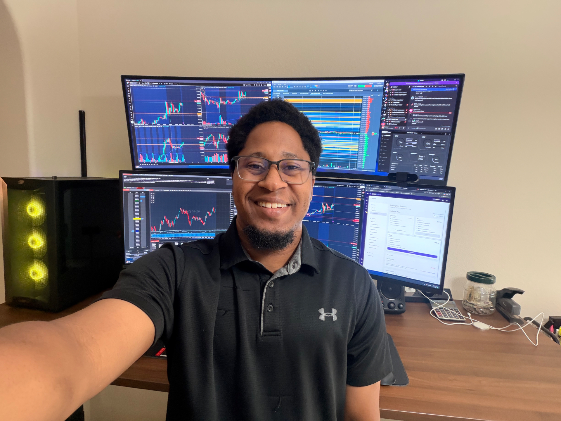 Lorenzo, an NQ futures trader, smiling in front of his multi-monitor trading desk showing live futures charts